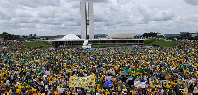 Thousands of demonstrators take part in a protest against the government of Brazil's President Dilma Rousseff, in front of the Brazilian National Congress, in Brasilia, Brazil, Sunday, March 15, 2015. Protests have been called for across Brazil to demonstrate against President Dilma Rousseff, whose popularity has never been lower as she faces a sputtering economy and a massive corruption scandal. (AP Photo/Eraldo Peres)