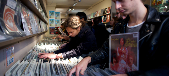 Young people look through vinyl records in a shop during the Berwick St Record Store Day in central London on April 19, 2014. AFP PHOTO / ANDREW COWIE (Photo credit should read ANDREW COWIE/AFP/Getty Images)