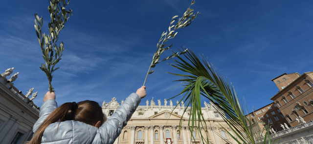 A girl waves palms during the Palm Sunday celebrations at St Peter's square on March 29, 2015 at the Vatican. AFP PHOTO / ALBERTO PIZZOLI (Photo credit should read ALBERTO PIZZOLI/AFP/Getty Images)