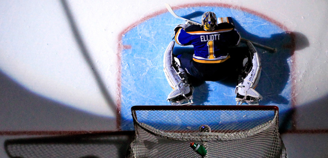 St. Louis Blues goalie Brian Elliott stretches prior to the start of an NHL hockey game against the Minnesota Wild, Saturday, March 14, 2015, in St. Louis. Minnesota won the game 3-1. (AP Photo/Billy Hurst)