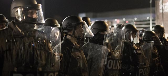 (141129) -- FERGUSON, Nov. 29, 2014 (Xinhua) -- Police in riot gear prepare to rush protesters and arrest any standing in the street in Ferguson, Missouri, the United States, on Nov. 28, 2014. Police arrested 15 people Friday night as about 100 protesters blocked traffic in front of the local police department in Ferguson. 
The protest was the latest one in reaction to the non-indictment of police officer Darren Wilson, who shot and killed unarmed 18-year-old black youth Michael Brown in August. 
(Xinhua/Jim Vondruska)