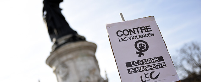 A sign reads "On March 8, I protest against violence" during a parade marking International Women's Day in Paris on March 8, 2015. AFP PHOTO / LOIC VENANCE (Photo credit should read LOIC VENANCE/AFP/Getty Images)