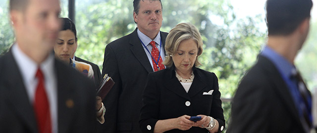 U.S. Secretary of State Hillary Rodham Clinton, center, uses a mobile phone after attending the Russia - U.S. meeting in Hanoi, Vietnam Friday, July 23, 2010. (AP Photo/Na Son-Nguyen, Pool)