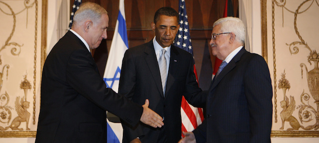 President Barack Obama watches as Israeli Prime Minister Benjamin Netanyahu and Palestinian President Mahmoud Abbas shake hands in New York, Tuesday, Sept. 22, 2009. (AP Photo/Charles Dharapak)