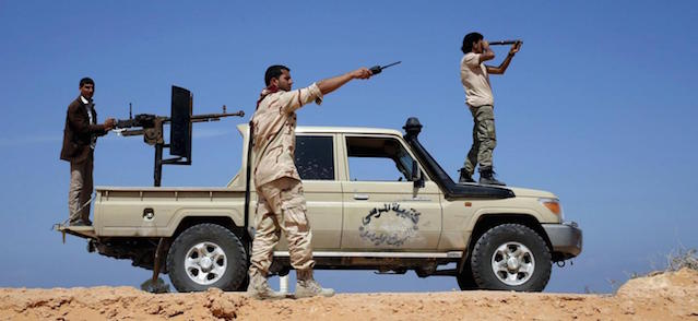 Libya Dawn fighters look at Islamic State (IS) militant positions near Sirte March 19, 2015. The Libya Dawn armed group backs the self-declared government in the capital Tripoli. REUTERS/Goran Tomasevic