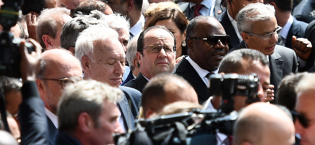 French President Francois Hollande, centre and President of Gabon Ali Bongo Ondimba centre right, take part in and anti-extremism march, in Tunis, Sunday, March 29, 2015. Tens of thousands of Tunisians attended a march in their country's capital, Tunis, on Sunday to denounce extremist violence following the attack on the National Bardo Museum. (AP Photo /Emmanuel Dunand, Pool)