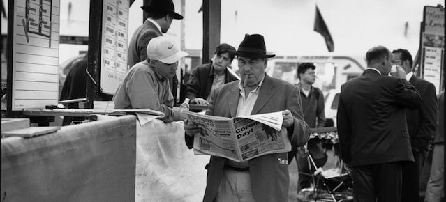 A tipster reading a newspaper at a bookmaker's stall at Epsom racecourse on Derby Day, 7th June 1997. (Photo by Steve Eason/Hulton Archive/Getty Images)