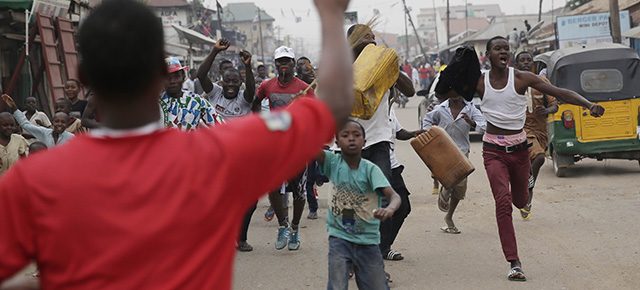 Residents celebrate the anticipated victory of Presidential candidate Muhammadu Buhari in Kaduna, Nigeria Tuesday, March 31, 2015. The spokesman for retired Gen. Muhammadu Buhari says the former military dictator has won Nigeria’s bitterly contested presidential election but fears “tricks” from the government. Garba Shehu told The Associated Press that their polling agents across the country tell them they have succeeded in defeating President Goodluck Jonathan.(AP Photo/Jerome Delay)