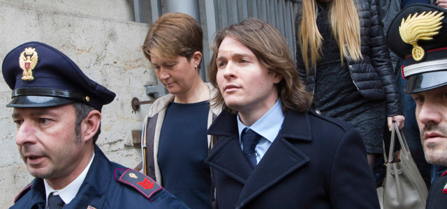 Raffaele Sollecito, center, leaves Italy's highest court building with his girlfriend Greta Menegaldo, in Rome, Friday, March 27, 2015. American Amanda Knox and her Italian ex-boyfriend expect to learn their fate Friday when Italy's highest court hears their appeal of their guilty verdicts in the brutal 2007 murder of Knox's British roommate Meredith Kercher. (AP Photo/Riccardo De Luca )