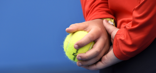 A ball kid holds a tennis ball during a second round match at the Australian Open tennis championship in Melbourne, Australia, Wednesday, Jan. 21, 2015. (AP Photo/Andy Brownbill)