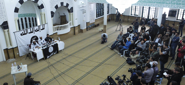 Saif Eddine Errais , center, spokesman of radical Islam Salafist group Ansar al-Sharia speaks during a press conference, Thursday, May 16, 2013 at the "Errahma" mosque in Cite Khadra, near Tunis. The conference focused on preparations of the annual congress schduled next Sunday in the historic city of Kairouan after Tunisia's government, led by the moderate Islamist Ennahda Party, decided to cancel the congress. (AP Photo/Amine Landoulsi)