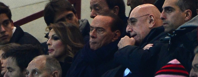 Italian former prime minister Silvio Berlusconi (C) takes place with AC Milan's sporting director Adriano Galliani before the Champions league match between AC Milan and Zenith St Petersburg on December 4, 2012 at the San Siro stadium in Milan. AFP PHOTO / OLIVIER MORIN (Photo credit should read OLIVIER MORIN/AFP/Getty Images)