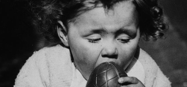 17th March 1938: A little girl from Cardiff eating an Easter egg. (Photo by Richards/Fox Photos/Getty Images)