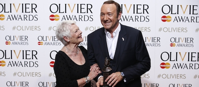 US actor, producer and director Kevin Spacey (R) poses with a special award recognising his contribution to British theatre during his tenure as Artistic Director of The Old Vic with British actress Judi Dench (L) during the Lawrence Olivier Awards for theatre at the Royal Opera House in central London on April 12, 2015. AFP PHOTO / JUSTIN TALLIS (Photo credit should read JUSTIN TALLIS/AFP/Getty Images)