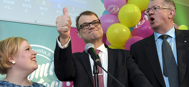 Annika Saarikko, left, Chairman Juha Sipilä centre, and Juha Rehula of the Centre Party celebrate at the party's parliamentary elections reception in Helsinki, Sunday April 19, 2015. Finland voted Sunday to determine which coalition could lift the country out of a three-year recession, with the opposition Center Party in an early lead over the ruling conservatives whose leader, Prime Minister Alexander Stubb, acknowledged his government was slow to enact economic reforms. (AP Photo / LEHTIKUVA / Markku Ulander / Lehtikuva via AP) FINLAND OUT NO SALES