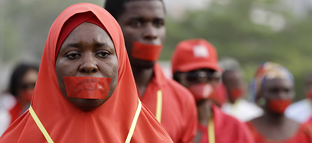 People march during a silent protest calling on the government to rescue the kidnapped girls of the government secondary school in Chibok, who were abducted a year ago, in Abuja, Nigeria, Monday, April 13, 2015. Nearly 300 schoolgirls from Chibok were abducted in a mass kidnapping on the night of April 14-15. Dozens escaped on their own but 219 remain missing. (AP Photo/Sunday Alamba)