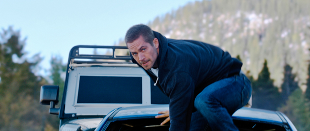 This photo provided by Universal Pictures shows Paul Walker as Brian in a scene from "Furious 7." When the high-speed action sequel “Furious 7” debuts this weekend, audiences at Hollywood’s famous TCL Chinese Theatre will see every tire skid and fist fight in Imax’s brand-new laser format. (AP Photo/Universal Pictures)