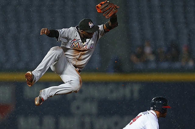 Atlanta Braves center fielder Eric Young Jr. (4) steals second base as Miami Marlins shortstop Adeiny Hechavarria (3) leaps for the wild throw in the fifth inning of a Major League baseball game Tuesday, April 14, 2015, in Atlanta. Young advanced to third. (AP Photo/John Bazemore)