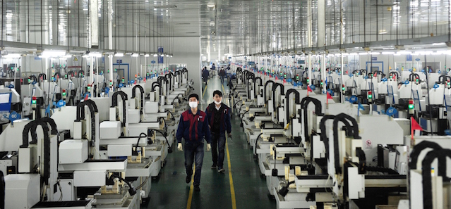 This picture taken on March 12, 2015 shows employees working in the workshop of Lens Technology in Liuyang, central China's Hunan province. Zhou Qunshu, a former factory worker who founded Lens Technology , a company supplying Apple, Samsung and other technological giants with touchscreen glass has become China's richest woman, reports said, with a fortune surpassing 8 billion USD. CHINA OUT AFP PHOTO (Photo credit should read STR/AFP/Getty Images)