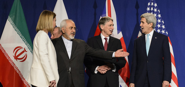 From left, EU High Representative for Foreign Affairs and Security Policy, Federica Mogherini, Iranian Foreign Minister, Mohammad Javad Zarif, British Foreign Secretary, Philip Hammond, and U.S. Secretary of State, John Kerry, line up for a press announcement after the end of a new round of Nuclear Iran Talks in the Learning Center at the Swiss federal Institute of Technology (EPFL), in Lausanne, Switzerland, Thursday, April 2, 2015. (AP Photo/Keystone, Jean-Christophe Bott)