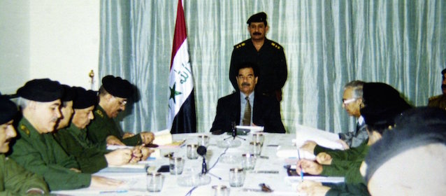 Iraqi President Saddam Hussein, seated center, leads a cabinet meeting Thursday in Baghdad, in this image released by the Iraqi News Agency Thursday, Sept. 19, 2002 . (AP Photo/INA)