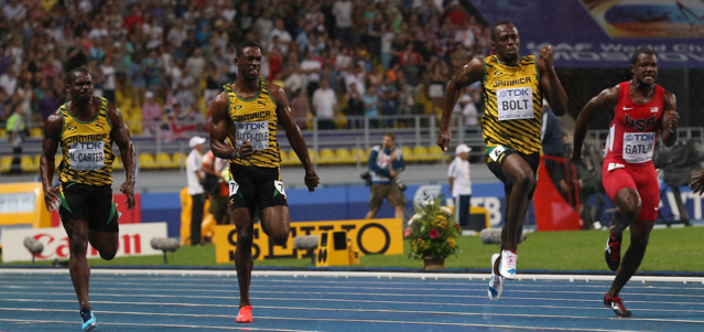 (L-R) Jamaica's Nesta Carter, Jamaica's Kemar Bailey-Cole, Jamaica's Usain Bolt and US Justin Gatlin run during the 100 metres final at the 2013 IAAF World Championships at the Luzhniki stadium in Moscow on August 11, 2013. Bolt timed a season's best 9.77 seconds, with American Justin Gatlin claiming silver in 9.85sec and Nesta Carter, also of Jamaica, taking bronze in 9.95sec. 
 AFP PHOTO / ALEXANDER NEMENOV (Photo credit should read ALEXANDER NEMENOV/AFP/Getty Images)