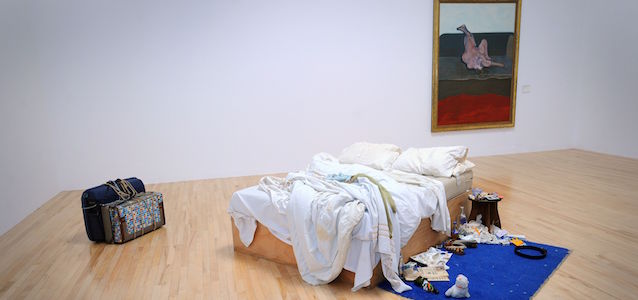 Tracey Emin's 'My Bed' installation as it returns to Tate Britain for the first time in 15 years in front of Francis Bacon's 'Reclining Woman' 1961. PRESS ASSOCIATION Photo. Picture date: Monday March 30, 2015. The artwork opens on Tuesday March 31 as part of the BP Walk through British Art display. See PA story ARTS Emin. Photo credit should read: Lauren Hurley/PA Wire