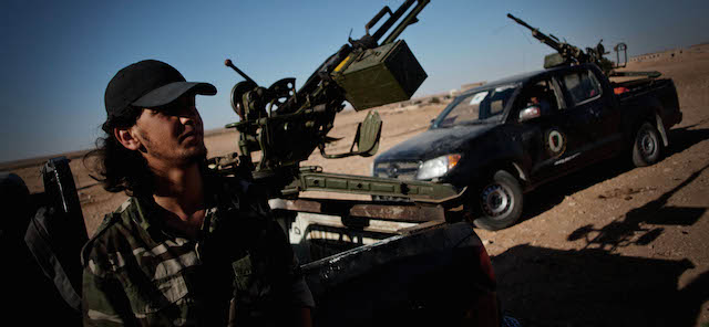 A Libyan militiaman stands at a check point near the border of Bani Walid in Misrata, Libya, Sunday, July 15, 2012. Tensions between the National Army and the former Gadaffi stronghold of Bani Walid have eased following the release of kidnapped journalists Abdelkader Fusuk and Youssef Baadi. (AP Photo/Manu Brabo)