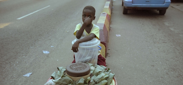 A child sits on the pavement along the road at night to hawk his wares in Akure, Ondo State in southwestern Nigeria, on March 24, 2015. Some 10.5 million children in Africa's most populous nation and leading economy are out of school -- the largest number in the world, according to the United Nations. Many children in the Muslim-majority north have little choice, with schools closed or destroyed by six years of fighting between Boko Haram and the military.
 But experts warn that even with recent successes against the militants, Nigeria needs to take urgent action to prevent an entire generation of children missing out on education. AFP PHOTO / PIUS UTOMI EKPEI (Photo credit should read PIUS UTOMI EKPEI/AFP/Getty Images)