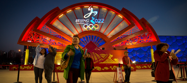 People take photos in front of a display for the proposed Beijing 2022 Winter Olympics on the Olympic Green in Beijing, Saturday, March 28, 2015. The International Olympic Committee (IOC) concluded a 5-day visit on Saturday to inspect Beijing's bid for the 2022 Winter Olympics. (AP Photo/Mark Schiefelbein)