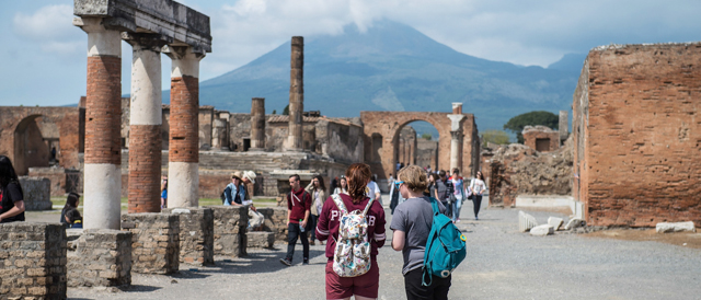 POMPEI, ITALY - APRIL 12: Tourists visit the ruins of the Foro (Forum) at the archeological site on April 12, 2014 in Pompei, Italy. The Italian government has enacted a series of provisions for the strengthening of the private security inside the archaeological site, following the recent theft of part of the fresco of Artemis. In 2013 Pompeii was visited by almost 2.5 million tourists. (Photo by Giorgio Cosulich/Getty Images)
