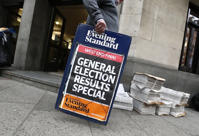A newspaper vendor sets out his stall in central London on May 8, 2015, a day after the British general election. British Prime Minister David Cameron's Conservative party on Friday won a majority in the House of Commons in the general election, results showed. AFP PHOTO / JUSTIN TALLIS (Photo credit should read JUSTIN TALLIS/AFP/Getty Images)