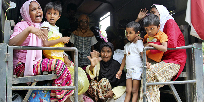 Ethnic Rohingya women and children whose boats were washed ashore on Sumatra Island board a military truck to be taken to a temporary shelter in Seunuddon, Aceh province, Indonesia, Sunday, May 10, 2015. Boats carrying about 500 members of Myanmar's long-persecuted Rohingya Muslim community washed to shore in western Indonesia on Sunday, with some of the people in need of medical attention, a migration official and a human rights advocate said. (AP Photo/S. Yulinnas)