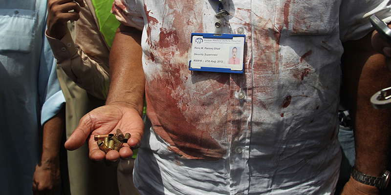 A Pakistani security official displays cartridges he collected from the scene of an attack on a bus, in Karachi, Pakistan, Wednesday, May 13, 2015. Gunmen killed dozens of people on Wednesday aboard a bus in southern Pakistan bound for a Shiite community center, in the latest attack targeting the religious minority, police said. (AP Photo/Fareed Khan)
