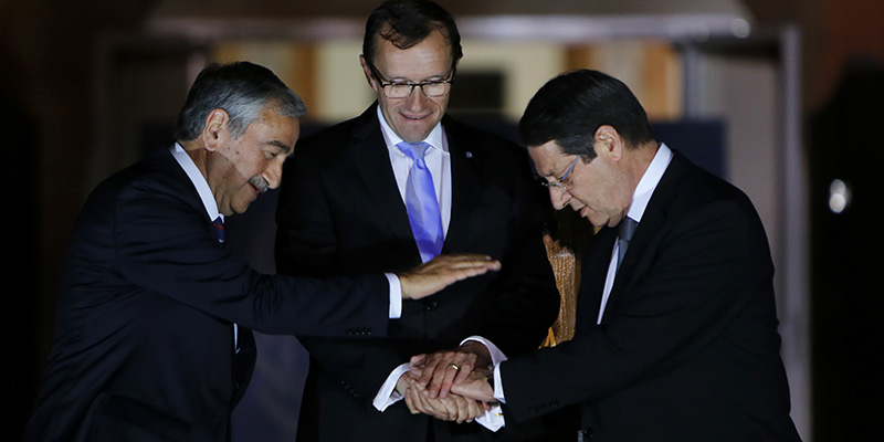 Cyprus' president Nicos Anastasiades, right, Turkish Cypriot leader Mustafa Akinci, left, and United Nations envoy Espen Barth Eide shake hands after a dinner at the Ledra Palace Hotel inside the UN controlled buffer zone that divides the Cypriot capital Nicosia, on Monday, May 11, 2015. The dinner is the first meeting between Anastasiades and Akinci since the Turkish Cypriot politician _ a left-wing moderate _ soundly defeated the hard-line incumbent in an election last month. Eide said that the two leaders agreed to relaunch stalled talks to reunify the ethnically divided island on May 15. Cyprus was split in 1974 when Turkey invaded after a coup by supporters of union with Greece. (AP Photo/Petros Karadjias)