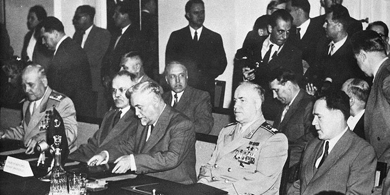 Soviet leaders sit at a conference table in the Parliament building in Warsaw, Poland, May 14, 1955, to draft a treaty that will establish a unified military command to rival NATO. From left to right: Soviet Marshal Ivan Konev, supreme commander of the alliance; Vyacheslav M. Molotov, Soviet foreign minister; Premier Nikolai Bulganin; and defense minister Georgi Zhukov. Others are unidentified. (AP Photo)
