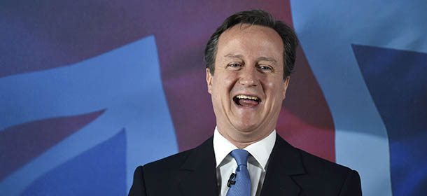Britain's Prime Minister David Cameron laughs, as he makes a speech, during a General Election campaign visit to Croydon, in Surrey, England, Saturday April 25, 2015. Britain goes to the polls in a general election on May 7. (Toby Melville, Pool Photo via AP)
