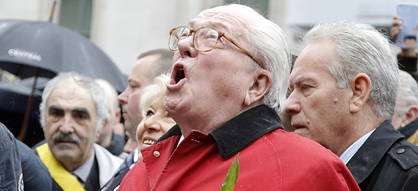 France’s far-right National Front party’s founder Jean-Marie Le Pen screams "Help Jeanne d'Arc" after he places a wreath at Joan of Arc's statue during its annual May Day march, in Paris, France, Friday, May 1, 2015. France’s far-right National Front is holding its annual May Day march, but for the first time the party’s founder Jean-Marie Le Pen is not taking a seat at the tribune. (AP Photo/Francois Mori)