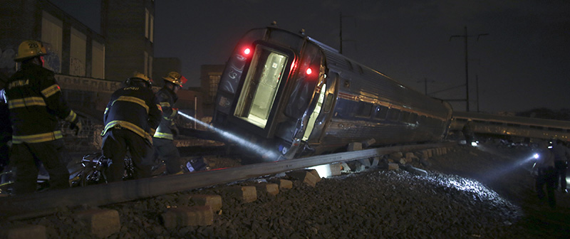 Emergency personnel work the scene of a deadly train wreck, Tuesday, May 12, 2015, in Philadelphia. An Amtrak train headed to New York City derailed and tipped over in Philadelphia. (AP Photo/ Joseph Kaczmarek)