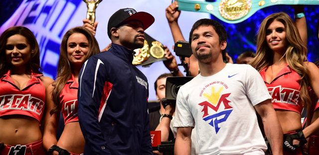 Floyd Mayweather and Manny Pacquiao on stage after facing-off with one another following their weigh-in on May 1, 2015 in Las Vegas, Nevada one day before their "Fight of the Century" on May 2 at the MGM Grand Garden Arena. AFP PHOTO / FREDERIC J. BROWN (Photo credit should read FREDERIC J. BROWN/AFP/Getty Images)