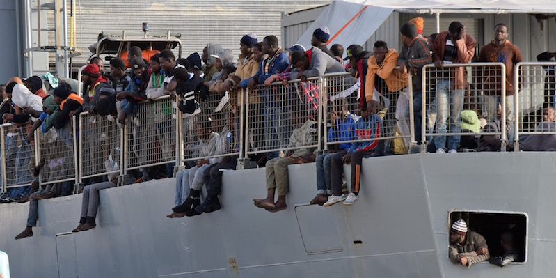 Migrants wait to disembark from a military ship following a rescue operation at sea as part of the Frontex-coordinated Operation Triton, on May 6, 2015 in Messina harbour. Italy's coastguard said it had rescued a total of 650 migrants yesterday and a total of over 1,700 were landed at various ports today as a consequence of what was one of the busiest weekends on record for rescues in the waters off Libya. AFP PHOTO / GIOVANNI ISOLINO (Photo credit should read GIOVANNI ISOLINO/AFP/Getty Images)