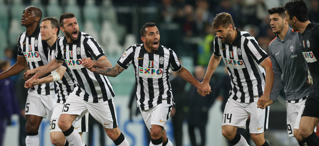 Juventus' Argentinian forward Alberto Carlos Tevez (C) who scored, celebrates with teammates after their victory 3-2 after the Italian Serie A football match Juventus Vs Fiorentina on April 29, 2015 at the "Juventus Stadium" in Turin. AFP PHOTO / MARCO BERTORELLO (Photo credit should read MARCO BERTORELLO/AFP/Getty Images)