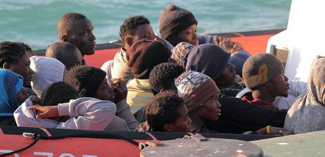 Migrants on a Coast Guard dinghy boat arrive at the Sicilian Porto Empedocle harbor, Italy, Monday, April 13, 2015. Italy's Coast Guard helped save 144 migrants Monday from a capsized boat in the waters off Libya and spotted nine bodies. It was the most dramatic of numerous rescue operations that brought thousands to safety in recent days, as good weather has encouraged the desperate to set out on smugglers' vessels. The overturned boat was spotted 80 miles north of Libya, Coast Guard Cmdr. Filippo Marini told The Associated Press in a telephone interview. (AP Photo/Calogero Montanalampo)