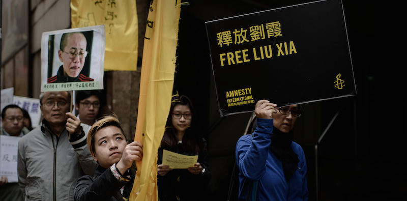 Una manifestazione per i diritti umani a Hong Kong, marzo 2014. (PHILIPPE LOPEZ/AFP/Getty Images)