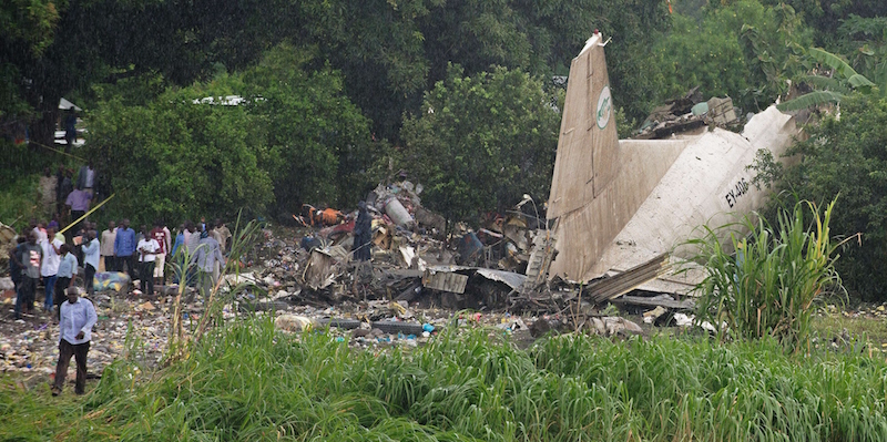 People gather at the site where a cargo plane crashed into a small farming community on a small island in the White Nile river, close to Juba airport in the Hai Gabat residential area, on November 4, 2015. At least 25 people were killed on November 4 when a plane crash-landed shortly after taking off from South Sudan's capital Juba, an AFP reporter said. AFP PHOTO/Charles Lomodong (Photo credit should read CHARLES LOMODONG/AFP/Getty Images)