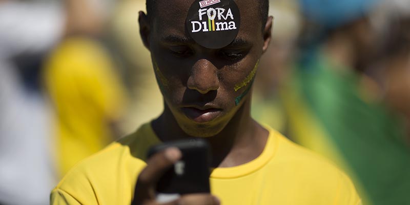 Un attivista dell'opposizione durante una manifestazione contro Dilma Rousseff a Rio de Janeiro lo scorso 16 agosto. (AP Photo/Leo Correa)