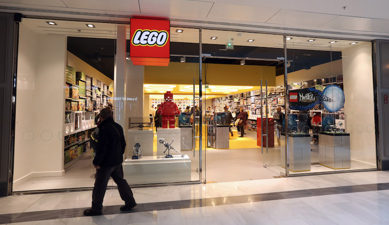 A man passes by the newly-opened store of Danish construction toys group Lego on October 18, 2012 at the "So Ouest" shopping center in Levallois-Perret, west of Paris. AFP PHOTO/THOMAS SAMSON (Photo credit should read THOMAS SAMSON/AFP/Getty Images)