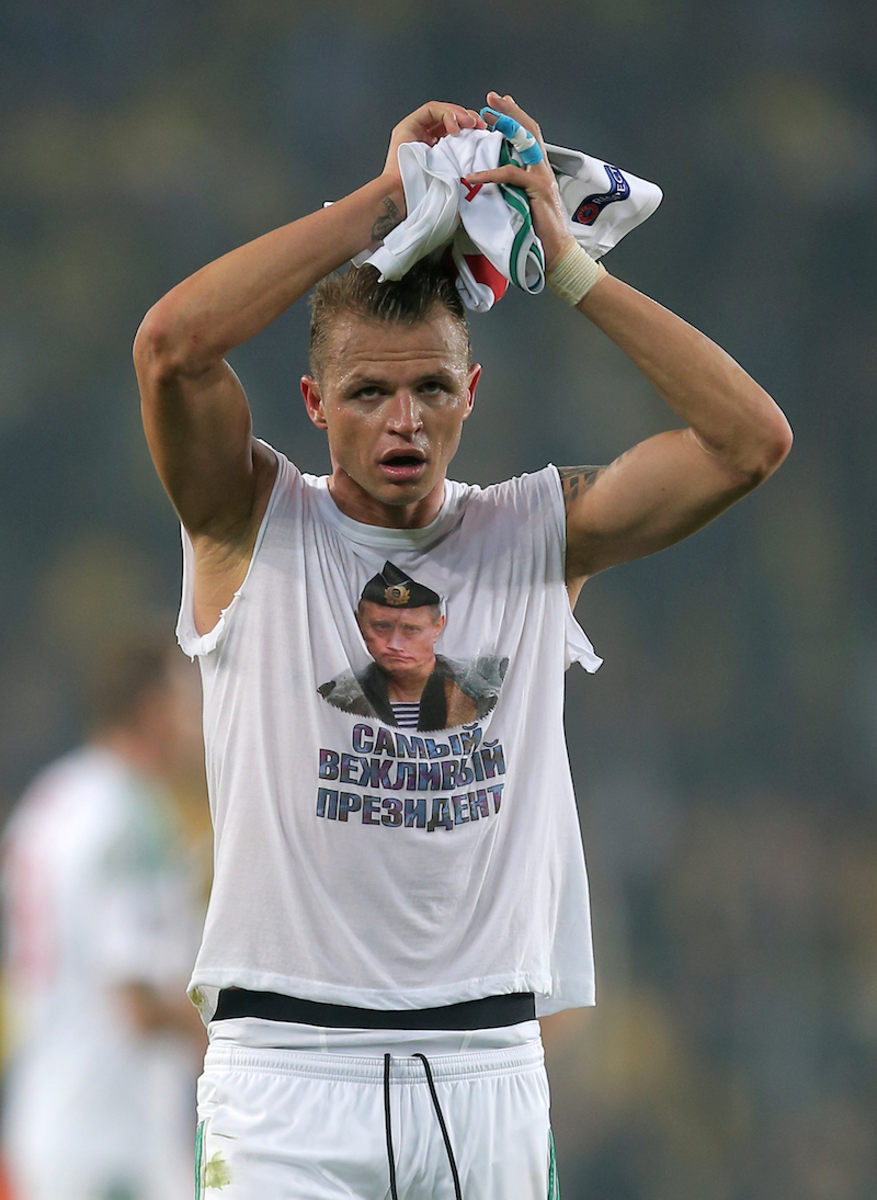 Lokomotiv Moscow's Dmitri Tarasov wears a shirt showing Russian President Vladimir Putin that reads 'Most polite president' after the UEFA Europa League round of 32 first leg football match between Fenerbahce and Lokomotiv Moscow at Sukru Saracoglu Stadium, in Istanbul on February 16, 2016. 
Fenerbahce won the match 2-0. / AFP / STR (Photo credit should read STR/AFP/Getty Images)