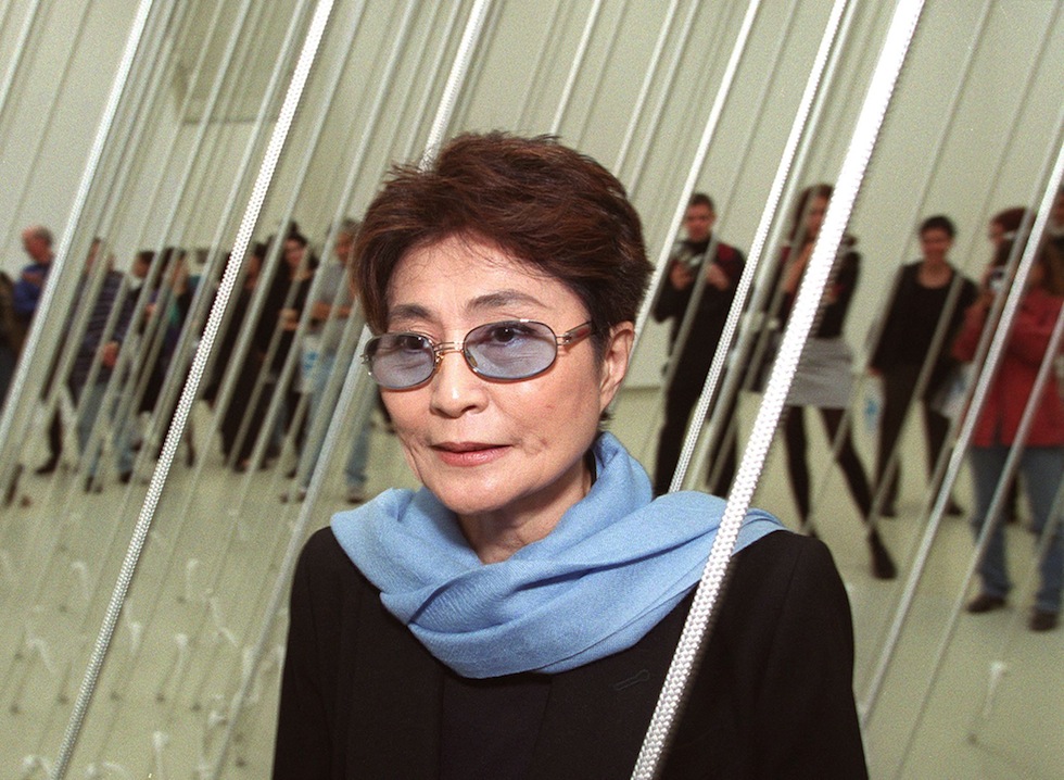 JERUSALEM:Artist Yoko Ono, widow of the late John Lennon, poses in front of one of her artworks from a retrospective show at the Israeli Museum in Jerusalem 25 November 1999. The exhibition, titled "Yoko Ono: Have You Seen the Horizon Lately", will be inaugurated November 26 to promote Ono's efforts to advance world peace and unity. Ono, 66, will also open another exhibition in Um el-Fahm, an Arab town in central Israel. (Photo credit should read MENAHEM KAHANA/AFP/Getty Images)