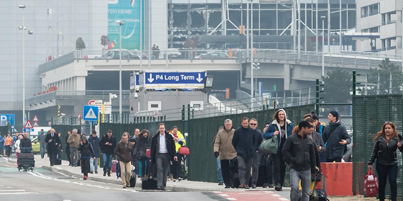 Alcune persone mentre lasciano l'aeroporto Zaventem di Bruxelles dopo le esplosioni (AP Photo/Geert Vanden Wijngaert)